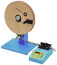 Preview: The image shows a device with a large, round cardboard disc mounted on a blue stand. Next to the disc is a digital control panel with buttons.