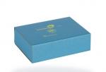 Preview: The image shows a square, turquoise cardboard packaging. On the top, there are some symbols and text printed in yellow. The box appears simple and modern.