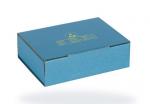 Preview: The image shows a rectangular, blue cardboard box with a smooth surface. On the top, there is a yellow graphic and some prints. The box has a flat shape and is closed.