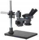Preview: The image shows a microscope with two eyepieces. It is mounted on a sturdy, rectangular base. The stand is made of metal and has an adjustable eyepiece element.