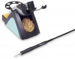 Preview: The image shows a soldering iron with a stand. The stand has a round holder and is black with a blue element. Next to it is a soldering tip cleaner with a wire ball.