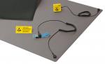 Preview: The image displays an antistatic work mat in shades of gray. On the mat, there is a yellow ESD warning sign and a clamping system with cable. All parts are designed for ESD protection.