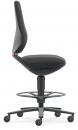 Preview: The office chair is black with an ergonomic backrest and seat. It has a central stand and five rolling legs with yellow wheels. A foot ring is present.