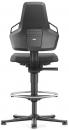 Preview: The image shows a modern office chair from the back. It has a high backrest, armrests, and a padded seat. A round footrest is visible underneath. The chair has wheels and is black.