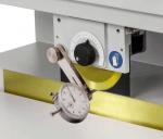 Preview: The image shows a machine with a round, yellow cutter and a measuring device. On the side, there is a black button and a safety symbol for hands.