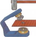 Preview: The image shows a lever device with a grey weight of 200 g. A screw with a roller presses on a red metal piece to secure it.