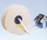 Preview: The image shows a large, round roll made of light material, with a mechanism attached to it that includes a motor. A belt connects the roll to the mechanism.